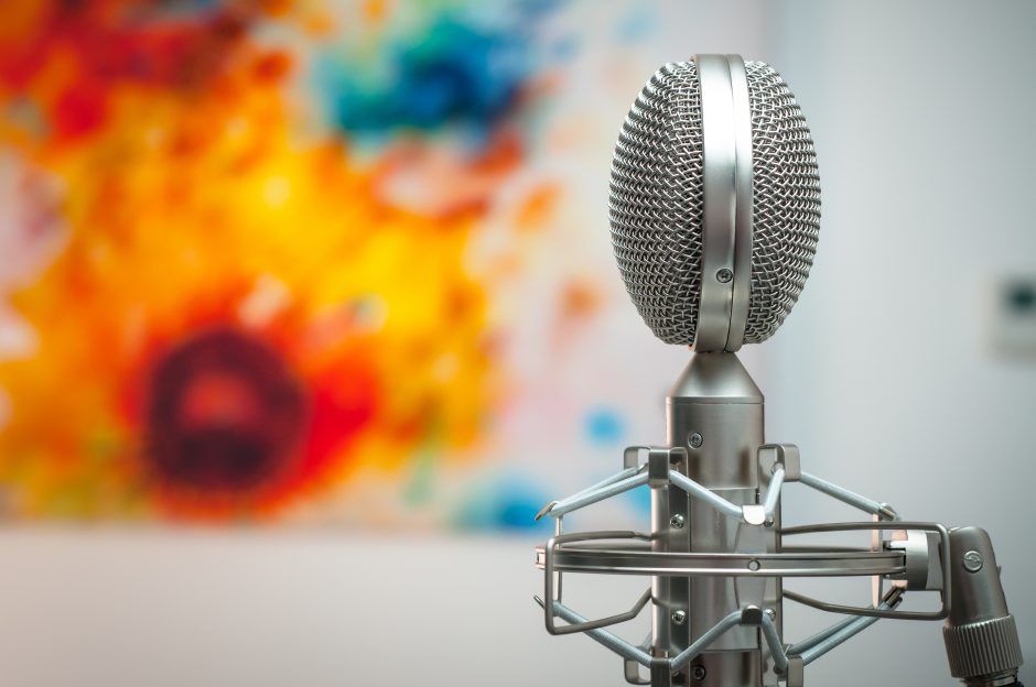 Image showing microphone in front of blurred painting in the background.